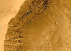 Channels in a Martian crater, in an image taken in 2000 by the Mars Global Surveyor, suggest to scientists that liquid water may have flowed across the surface of Mars in recent times.